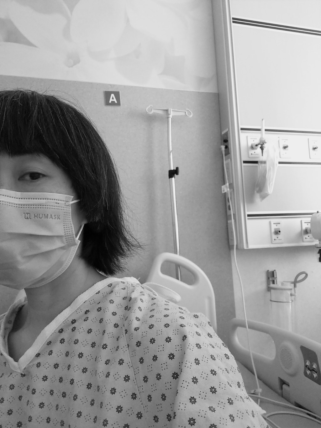 wearing a hospital gown